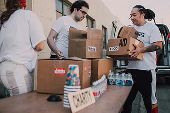 volunteer people, white shirts, aid boxes, food, medicine, charity, outdoor, van, loading, volunteers, boxes