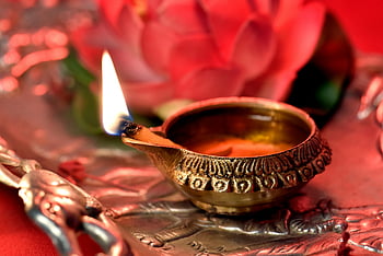 lighted diya, brass diya, silver tray, Diwali celebrations, close-up diya, lit diya, festive diya, traditional diya, diya on tray, diya flame, diya decoration