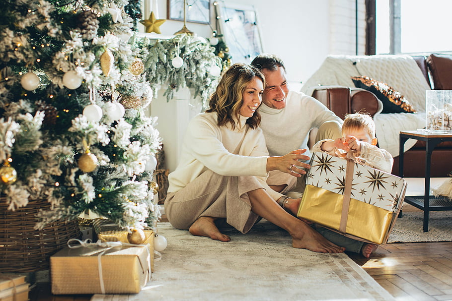 unboxing, Christmas gift, decorated tree, happy family, indoor scene, holiday season, festive atmosphere, gift wrapping, family time, Christmas celebration, unboxing moment