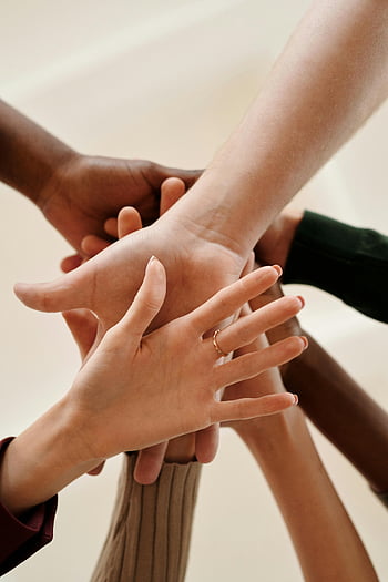 Unity Hands, diverse hands, teamwork, cooperation, unity, close-up, indoors, joined hands, symbolizing unity, multi-ethnic hands, collaboration