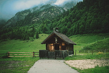 Brown Wooden House, surrounded by grass, charming wooden cabin, lush green valley, misty mountains, rural serenity, wooden cabin, green valley, rural scene, serene landscape