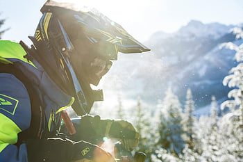 snowmobiling, snowy mountain, winter adventure, person snowmobiling, snowy landscape, winter sports, mountain adventure, outdoor adventure, snowmobile rider, winter scenery, snow-covered mountains