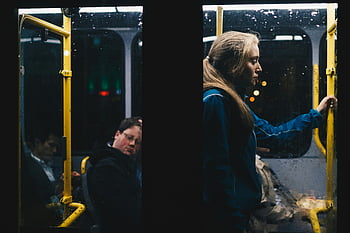woman, standing, inside, bus, dimly lit, Dublin city bus, nightly commute, solitary woman, public transportation, urban scene, evening travel