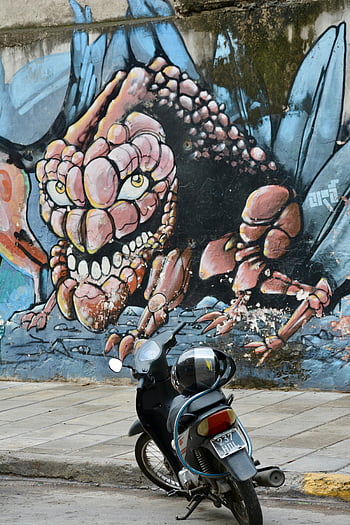 Black Underbone Motorcycle, graffiti monster, urban street art, colorful graffiti, motorcycle parked, pathway, wall art, street scene, urban environment, outdoor art, cityscape