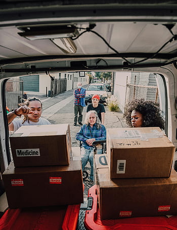 volunteers, loading boxes, medicine, community aid, diverse group, van, boxes labeled medicine, community service, charitable work, aid delivery, volunteers in action