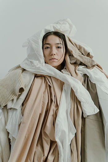 woman wrapped in fabrics, neutral-colored fabrics, draped woman, style portrait, introspective portrait, layered fabrics, fashion portrait, artistic portrait, neutral tones, fabric art, woman in layers