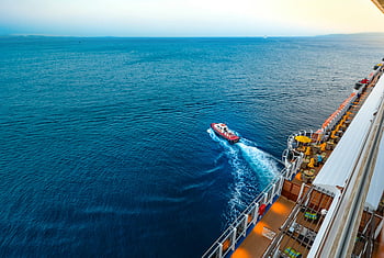 cruise ship, luxury cruise, small boat, vast ocean, sunset view, high angle view, people sailing, ocean scenery, cruise deck, aerial view, sunset ocean