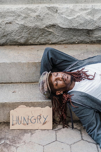 homeless man, sleeping, concrete steps, hungry sign, poverty, homelessness, street life, urban poverty, destitute, social issues, hardship
