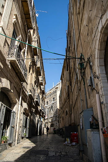 Brown concrete buildings, narrow stone street, Jerusalem's Old City, historical architecture, stone architecture, narrow alley, old city streets, historical buildings, stone buildings, narrow streets, Jerusalem architecture