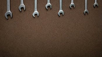 spanners, wooden board, top down view, flat lay, workshop tools, brown OSB board, open end wrenches, lined up, copy space, textured background, wrenches