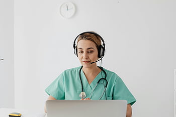 female doctor, scrubs, laptop, virtual consultation, telemedicine, online meeting, patient, headset, stethoscope, medical professional, healthcare