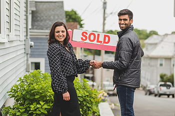 home buying, real estate deal, sold sign, house purchase, property transaction, home ownership, realtor handshake, new home buyers, residential real estate, home sale, home buyers celebration