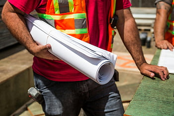 construction workers, safety vests, holding blueprints, drafting paper, construction site, daytime, blueprints, safety gear, construction plans, work site, outdoor work