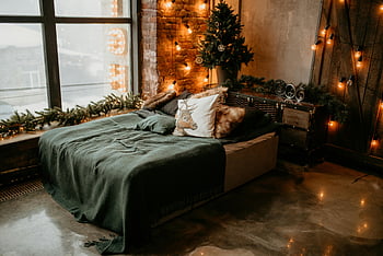 Green Bedspread, Christmas tree, cozy bedding, warm bedroom, soft lighting, decorated bedroom, festive decor, holiday atmosphere, indoor Christmas, rustic bedroom, string lights