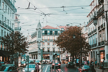 Lisbon, Portugal, classic architecture, urban traffic, bustling street, cityscape, European city, street scene, tram lines, historic buildings, lively traffic