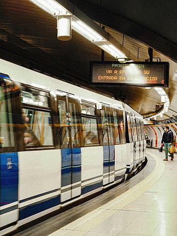 subway station Madrid, blurred subway train, urban energy, Madrid station, subway train, urban transportation, public transport, underground station, city life, train station, Madrid metro