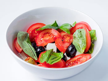 Caprese salad, close-up shot, fresh ingredients, tomatoes, basil, olives, bowl, delicious, colorful, healthy meal, vegetarian dish
