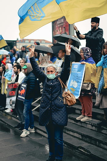 protesters, Ukrainian flags, city stairs, masks, demonstration, anti-Putin, NATO, outdoor protest, public demonstration, political rally, city protest