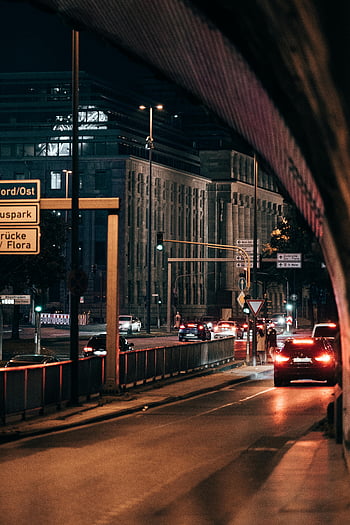 city road, night time, illuminated street, urban setting, cars, buildings, nightlife, city living, street lights, traffic, night scene