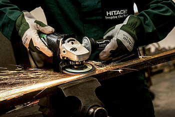 angle grinder, Hitachi angle grinder, metal grinding, sparks, industrial workshop, skilled worker, black and gray grinder, Hitachi tool, metalworking, safety gloves, industrial equipment
