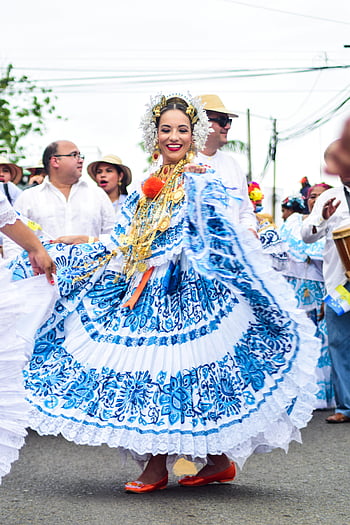 woman in white and blue costume, dancing, Panamanian parade, traditional attire, festive dancers, vibrant costume, outdoor celebration, cultural event, traditional dance, Panamanian culture, parade celebration