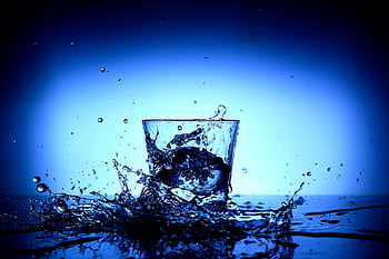 drinking glass, body of water, vibrant close-up, water splashing, dynamic motion, reflections, blue background, glass with water, water droplets, splashing water, glass reflections