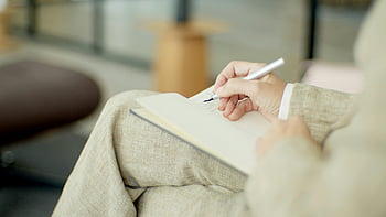 person writing, notebook, pen, close-up, indoors, writing in notebook, hand writing, indoor writing, notebook writing, person with pen, indoor scene