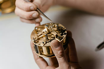 copper clock mechanism, watchmaker, fixing clock, precision, skill, detailed view, clock repair, mechanical watch, clockwork, hands-on work, craftsmanship