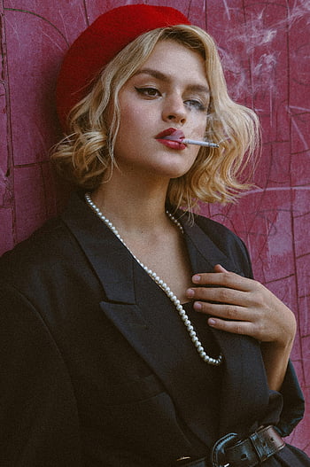 thoughtful woman, cigarette, shabby wall, elegant young woman, red beret, black jacket, smoking, confidence, individuality, pearl necklace, red wall