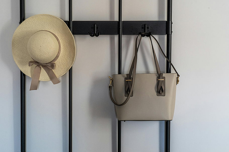 ige hat, grey sling bag, black metal hook, stylish sun hat, leather handbag, modern wall hook, indoor hanging, fashion accessories, home decor, wall organizer, beige accessories