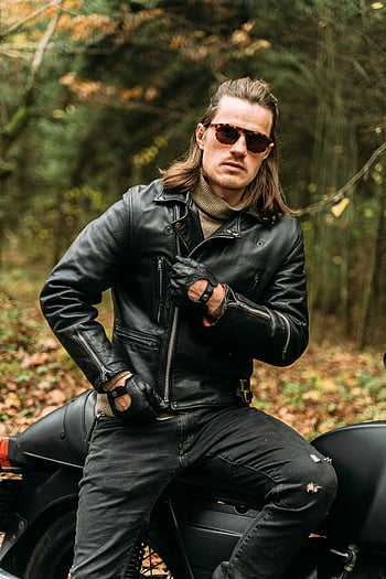 man, motorcycle, forest, sunglasses, leather jacket, stylish biker, parked motorcycle, confident pose, outdoor setting, autumn leaves, black leather