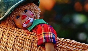 sad clown doll, colorful clown, sad expression, woven basket, close-up, clown doll, basket, colorful, sad face, toy, doll
