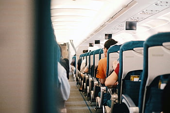 airplane interior, passengers seated, blue seats, airplane cabin, flight view, interior view, airplane passengers, cabin view, flight interior, airplane seats, seated passengers
