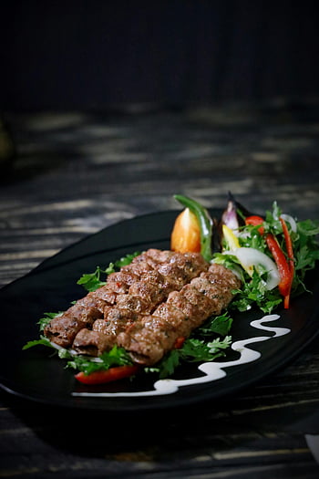 kebab, grilled kebab, black plate, fresh salad, close-up, food photography, meat dish, salad side, culinary, plate presentation, grilled meat