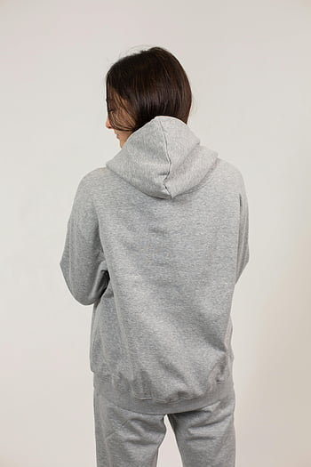 gray sweatpants, gray sweatshirt, cozy gray hoodie, young woman, indoor photo, white background, casual outfit, comfortable clothing, gray tracksuit, woman standing, cozy attire