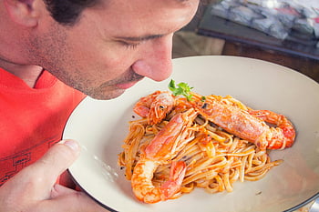 man smelling, prawn pasta dish, white ceramic plate, shrimp pasta, herbs, food lovers, aroma, man enjoying, pasta dish, white plate, shrimp aroma