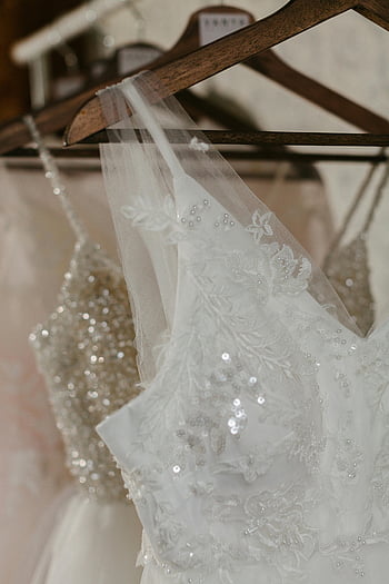 wedding dresses, hangers, elegant wedding dresses, sequins, lace details, close-up, bridal gowns, wedding attire, bridal fashion, wedding dress details, wedding dress hangers