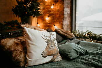 bedroom decor, festive decor, deer pillow, white and brown throw pillow, gray textile, warm bedroom, inviting bedroom, holiday decor, cozy bedroom, festive bedroom, deer-themed pillow