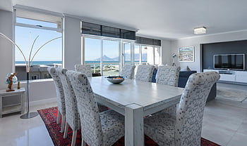 rectangular white wooden table, chairs, luxurious dining room, modern furniture, ocean views, Cape Town, dining table, dining chairs, interior design, coastal view, contemporary decor