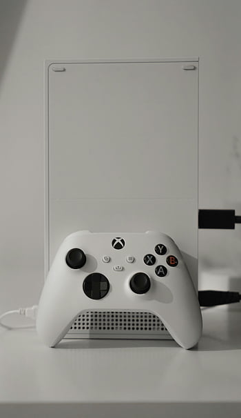 white Xbox One, game controller, sleek gaming console, wireless controller, minimalist table, white gaming console, Xbox One controller, white controller, gaming setup, minimalist setup, white Xbox