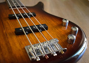 brown electric guitar, close-up guitar, guitar body, guitar strings, guitar controls, detailed guitar, electric bass guitar, guitar close-up, guitar details, guitar knobs, guitar hardware