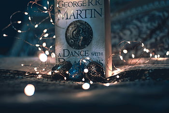 book, magical string lights, enchanting ambience, George R.R. Martin, A Dance with Dragons, captivating setup, string lights, book photography, literary ambiance, decorative lights, book display