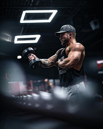 muscular man, gym workout, lifting dumbbells, indoor exercise, strength training, fitness, sportswear, bodybuilding, workout routine, gym environment, athletic man
