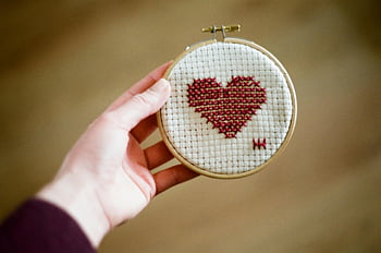 cross stitch, embroidered heart, white textile, red stitches, handmade craft, embroidery hoop, heart design, textile art, needlework, craft project, decorative stitching