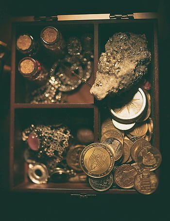 coins, jewelry, treasure box, large rock, collectibles, antique coins, gemstones, vintage jewelry, decorative items, treasure collection, coin collection
