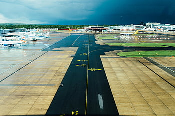 airport runway, parked planes, cloudy day, travel themes, aviation themes, aerial view, aircraft trail, black and brown, air travel, airport scene, runway markings