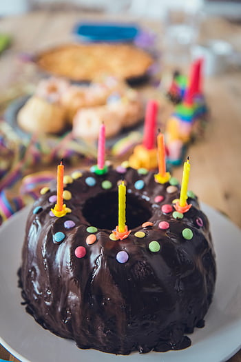chocolate cake, colorful candles, sprinkles, birthday celebration, close-up photo, delicious cake, chocolate frosting, festive cake, party dessert, sweet treat, birthday cake