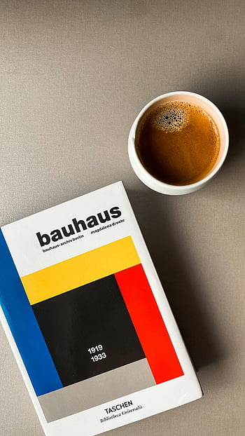 Bauhaus book, coffee cup, minimalist setup, warm aesthetic, inviting aesthetic, Bauhaus design, coffee and book, modern art, Taschen book, espresso cup, neutral background