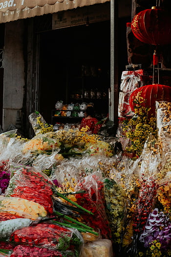 Bouquet of Flowers, colorful flowers, Phnom Penh market, traditional ambiance, market stall, floral display, red lanterns, vibrant blooms, flower arrangement, market scene, cultural setting