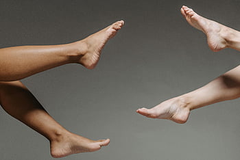 bare feet, close-up photo, diverse skin tones, gray backdrop, studio setting, artistic photography, human feet, foot art, skin diversity, foot close-up, studio photography